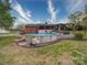 Backyard features an above ground pool with a deck and a brick home with a covered porch at 24436 Nc 24/27 Hwy, Albemarle, NC 28001
