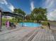 This above ground pool with a deck is surrounded by mature trees and a fenced yard at 24436 Nc 24/27 Hwy, Albemarle, NC 28001