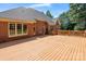 Spacious wooden back deck perfect for entertaining with brick exterior and multiple windows at 255 Honeysuckle Creek Loop, Mooresville, NC 28117