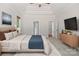 Cozy bedroom features a tray ceiling, ceiling fan, and windows at 255 Honeysuckle Creek Loop, Mooresville, NC 28117