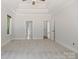Large bedroom features a tray ceiling, two doorways and a large window at 255 Honeysuckle Creek Loop, Mooresville, NC 28117