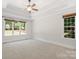 Spacious bedroom features a tray ceiling, ceiling fan and large windows at 255 Honeysuckle Creek Loop, Mooresville, NC 28117