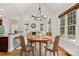 A dining room with a round wooden table and chairs positioned beneath a modern chandelier at 255 Honeysuckle Creek Loop, Mooresville, NC 28117