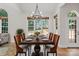 Dining room featuring a dark wood table with orange chairs and an elegant chandelier at 255 Honeysuckle Creek Loop, Mooresville, NC 28117