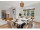 Elegant dining room featuring a modern table set, hardwood floors, and large bright windows at 255 Honeysuckle Creek Loop, Mooresville, NC 28117