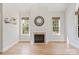 Cozy living room with a fireplace, large windows, and natural light enhancing the home's appeal at 255 Honeysuckle Creek Loop, Mooresville, NC 28117