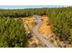 Aerial view of metal building, with a long dirt driveway and various vehicles on the property at 2710 Wyatt Grove Church Rd, Richfield, NC 28137
