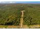 An aerial view of a large wooded homesite featuring a dirt road leading to the house at 2710 Wyatt Grove Church Rd, Richfield, NC 28137