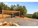 Exterior shot of a covered parking area with two Jeeps and gravel drive at 2710 Wyatt Grove Church Rd, Richfield, NC 28137