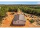 Aerial view of a white house with a metal roof, several cars, a covered car port, and large wooded area at 2710 Wyatt Grove Church Rd, Richfield, NC 28137