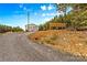 Wide exterior shot showing a garage, covered parking area, and gravel driveway at 2710 Wyatt Grove Church Rd, Richfield, NC 28137