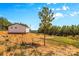 Exterior view of metal building with a single tree in the front yard, adjacent to a lawn and dirt space at 2710 Wyatt Grove Church Rd, Richfield, NC 28137