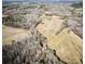 Aerial view of the property shows it set in a wooded landscape with open areas for building at 28926 Hartsell Rd, Albemarle, NC 28001