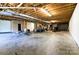 Large unfinished basement with exposed ceiling and concrete floor at 28926 Hartsell Rd, Albemarle, NC 28001