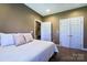 Comfortable bedroom with a queen bed, neutral tones, and ample closet space at 28926 Hartsell Rd, Albemarle, NC 28001