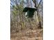 Elevated green hunting stand in a wooded area, offering hunters an elevated view at 28926 Hartsell Rd, Albemarle, NC 28001