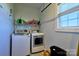 Laundry room featuring washer, dryer, shelf with detergents, and a window at 28926 Hartsell Rd, Albemarle, NC 28001