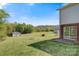 Large backyard with green grass, firepit, storage shed, and mature trees at 2948 Christy Leigh Dr, Newton, NC 28658
