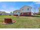 The backyard includes lush green grass, a firepit, bench, and a storage shed at 2948 Christy Leigh Dr, Newton, NC 28658