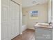 Neutral bathroom featuring tile floors, bathtub, window and closet at 2948 Christy Leigh Dr, Newton, NC 28658