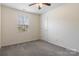 Cozy bedroom features plush carpeting, a ceiling fan, and a bright window at 2948 Christy Leigh Dr, Newton, NC 28658