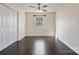 Cozy bedroom with dark wood vinyl flooring, natural lighting, and double door closet at 2948 Christy Leigh Dr, Newton, NC 28658