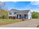 Charming two-story home featuring gray and blue siding, black shutters, and a well-maintained front yard with mature trees at 2948 Christy Leigh Dr, Newton, NC 28658