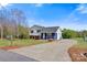 Beautiful home with a gray and blue exterior, black shutters, mature trees, and a long concrete driveway on a sunny day at 2948 Christy Leigh Dr, Newton, NC 28658