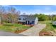 Charming split-level home with a well-manicured lawn and inviting blue accents on the front porch at 2948 Christy Leigh Dr, Newton, NC 28658