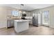 Modern kitchen with stainless steel appliances, gray cabinets, granite counters, center island, and wood-look floors at 2948 Christy Leigh Dr, Newton, NC 28658