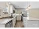 Lovely kitchen with stainless steel appliances, gray cabinets, marble countertops, center island, and wood-look floors at 2948 Christy Leigh Dr, Newton, NC 28658