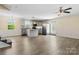Open-concept kitchen and living area with stainless appliances, gray cabinets, center island, and wood-look flooring at 2948 Christy Leigh Dr, Newton, NC 28658