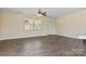 A bright open living room features luxury vinyl flooring, two windows and a ceiling fan at 2948 Christy Leigh Dr, Newton, NC 28658