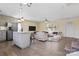 Open-concept living room with a kitchen island, light wood flooring, and modern white furniture at 2948 Christy Leigh Dr, Newton, NC 28658