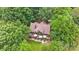 Aerial view of the home with a large deck and outdoor seating area surrounded by trees at 307 Stillwater Rd, Troutman, NC 28166