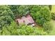 Aerial view of home surrounded by lush, mature trees and serene landscaping at 307 Stillwater Rd, Troutman, NC 28166