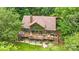 Aerial view of home featuring a multi-tiered deck, overlooking a lush wooded landscape at 307 Stillwater Rd, Troutman, NC 28166