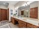 Bright bathroom with double vanity, large mirror, tiled floor, and glass-enclosed shower at 307 Stillwater Rd, Troutman, NC 28166