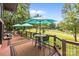 A charming deck showcases outdoor seating, a small dining set, and beautiful views of the manicured yard at 307 Stillwater Rd, Troutman, NC 28166
