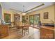 A formal dining room with wood floors and trim, a china cabinet, and a sliding glass door to the outdoor patio at 307 Stillwater Rd, Troutman, NC 28166