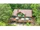 Aerial view of a home with a large deck surrounded by lush trees with green leaves at 307 Stillwater Rd, Troutman, NC 28166