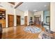 This spacious foyer features hardwood floors, decorative rug, and views into multiple rooms of this open floor plan home at 307 Stillwater Rd, Troutman, NC 28166