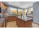 Open kitchen featuring tile flooring, stainless steel appliances, wooden cabinets, and center island at 307 Stillwater Rd, Troutman, NC 28166