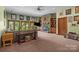 Inviting living room featuring a stone fireplace, built-in bookshelves, and a view of the backyard at 307 Stillwater Rd, Troutman, NC 28166