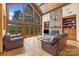 Spacious living room with vaulted ceiling, stone fireplace, and expansive windows showcasing the outdoor scenery at 307 Stillwater Rd, Troutman, NC 28166