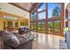A bright living room features hardwood floors, vaulted ceilings and a wall of windows providing a stunning view of the backyard at 307 Stillwater Rd, Troutman, NC 28166