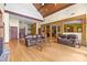 Spacious living room with hardwood floors, high ceilings, exposed beams and an open layout into the dining and kitchen area at 307 Stillwater Rd, Troutman, NC 28166