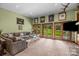 Spacious living room with large windows, comfortable seating, and views of the green backyard at 307 Stillwater Rd, Troutman, NC 28166