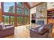 Bright living room featuring vaulted ceiling, stone fireplace, and large windows with outdoor views at 307 Stillwater Rd, Troutman, NC 28166