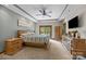 Well-lit main bedroom with neutral walls, recessed lighting, ceiling fan, and wood furniture at 307 Stillwater Rd, Troutman, NC 28166